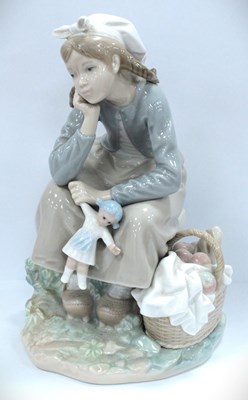 Lot 1253 - Lladro figure of a small girl holding a doll...