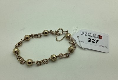 Lot 227 - A Modern 9ct Gold Bracelet, of textured bead...
