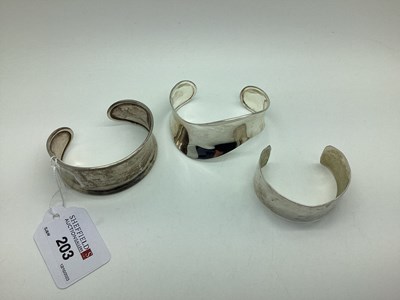 Lot 203 - A Modern Cuff Bangle, of wavy design...