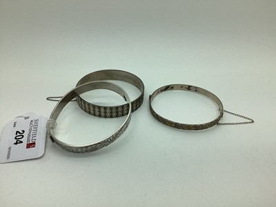 Lot 204 - Three Hallmarked Silver Hinged Bangles, each...