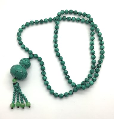 Lot 190 - Polished Bead Necklace, suspending shaped drop...