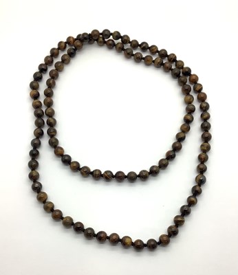 Lot 191 - A Polished Tiger's Eye Single Strand Bead...