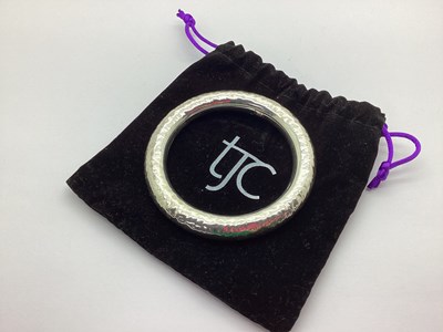 Lot 230 - A Modern Chunky Bangle, of textured design,...