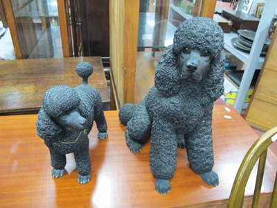 Lot 1165 - Two Leonardo Black Poodle Figures, the tallest...