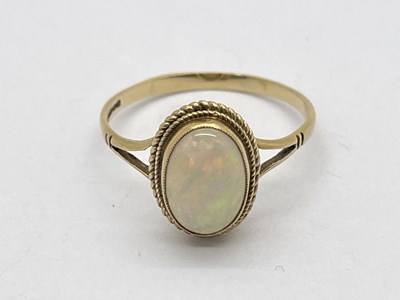 Lot 76 - A 9ct Gold Opal Single Stone Dress Ring, oval...