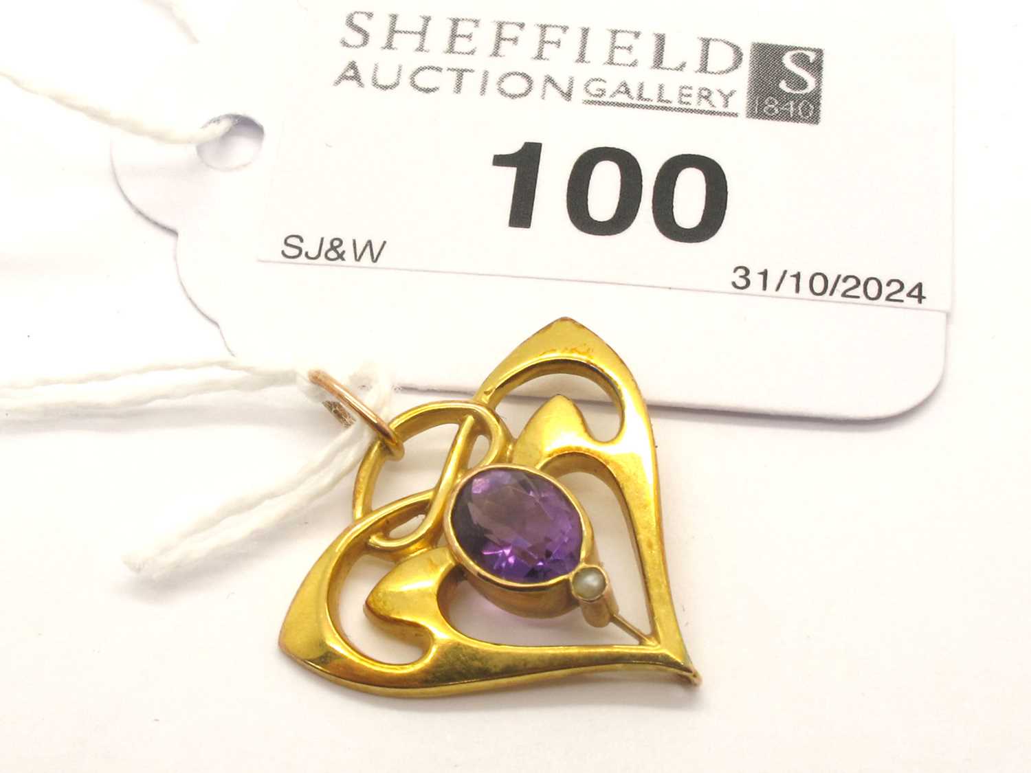 Lot 100 - An Art Nouveau Amethyst Set Pendant, of...