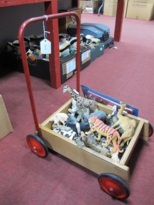 Lot 1095 - Childs Pusher, plastic figures of animals.