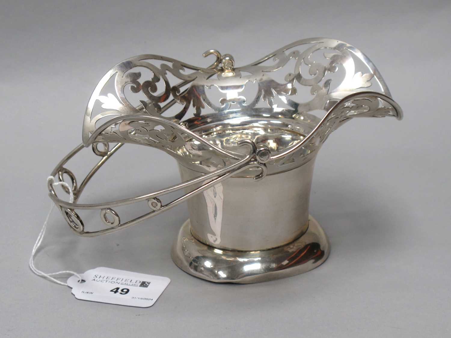 Lot 49 - An Edwardian Hallmarked Silver Swing Handled...