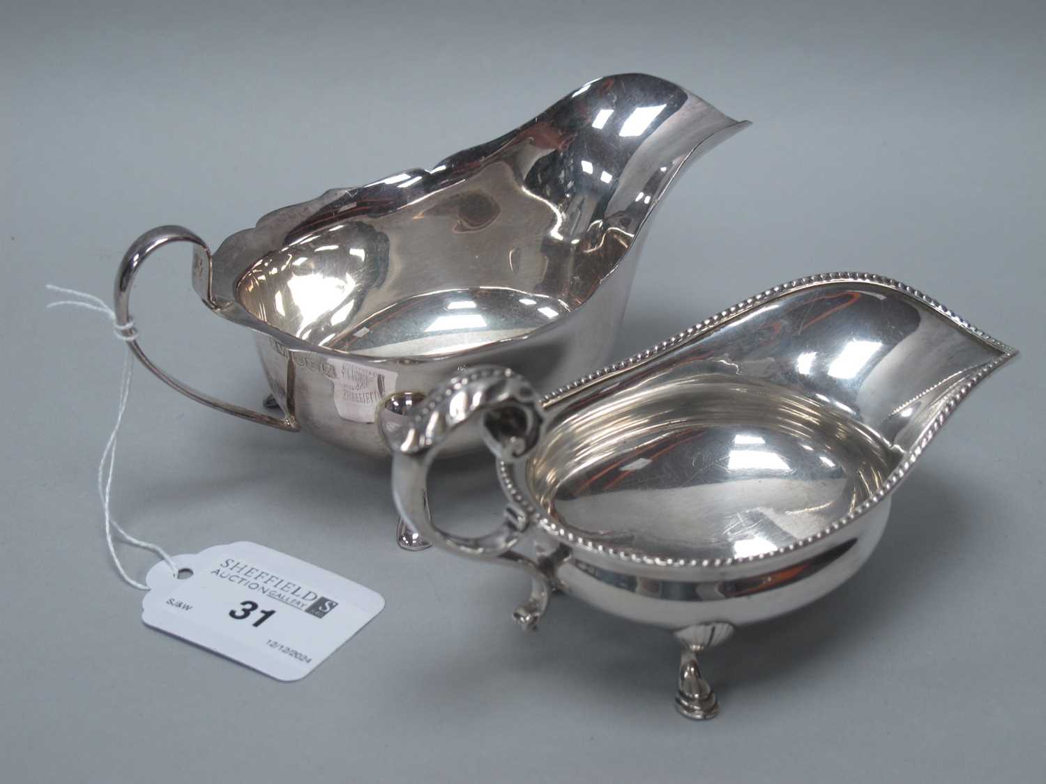 Lot 31 - An Edwardian Hallmarked Silver Sauce Boat,...