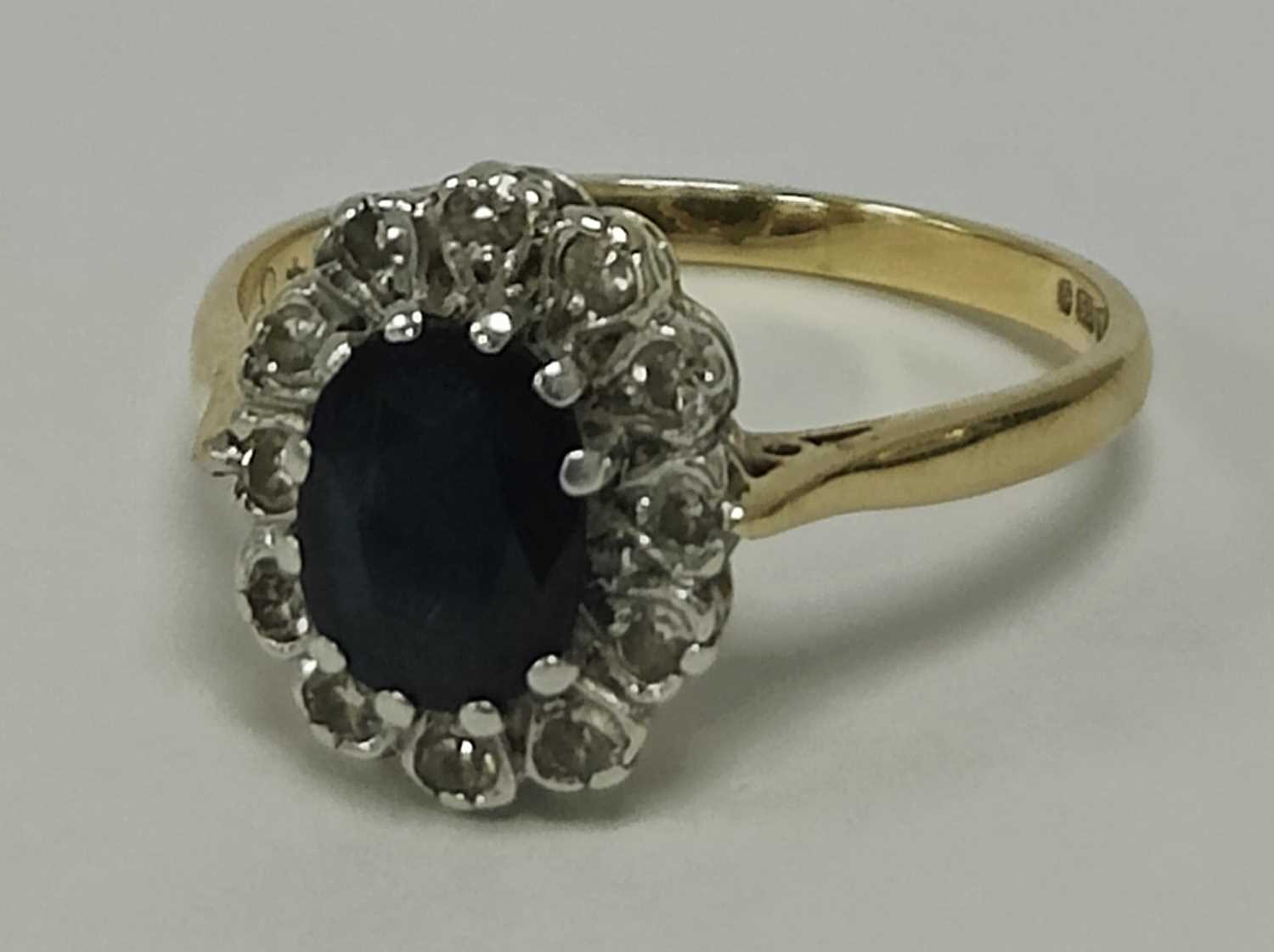 Lot 45 - A 9ct Gold Stone Set Cluster Ring, the oval...