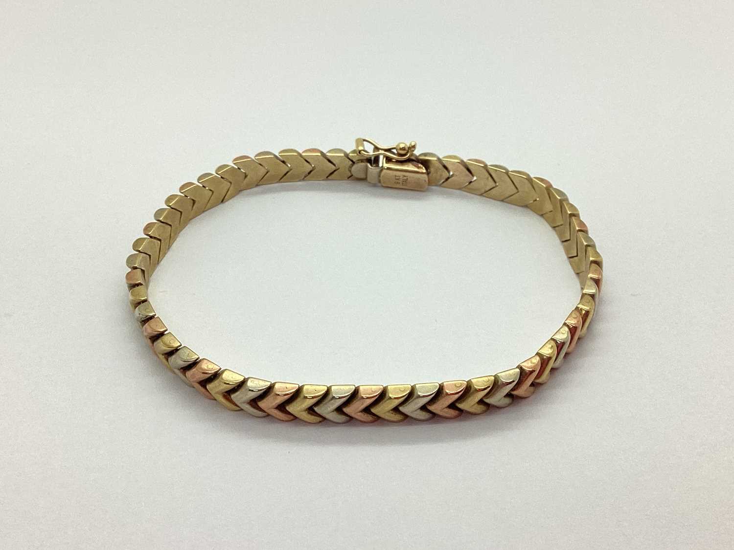 Lot 72 - A Three Colour Bracelet, of chevron design, to...