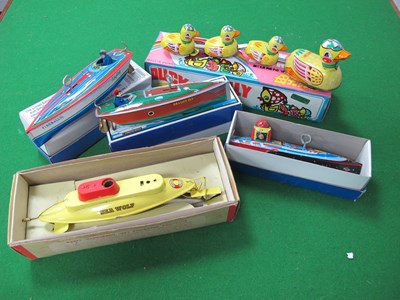 Lot 652 - A collection of tinplate toys to include a...