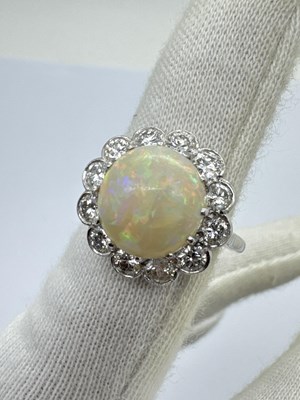 Lot 251 - A Large Opal and Diamond Cluster Ring, the...