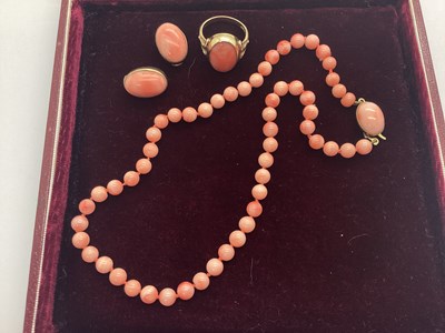 Lot 183 - A 9ct Gold Coral Dress Ring, oval collet...