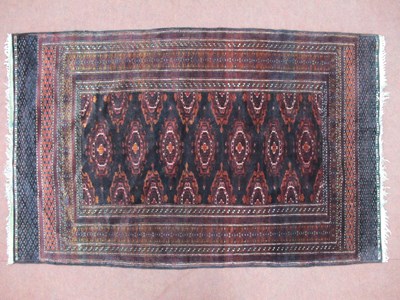 Lot 1547 - A Middle Eastern Rug, in shades of maroon,...