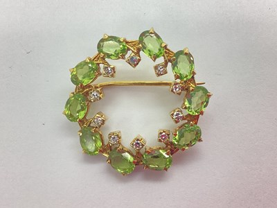 Lot 216 - A Diamond and Peridot Set Openwork Circle...