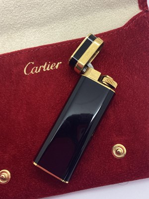 Lot 300 - Cartier; A Gold Plated and Black Lighter,...