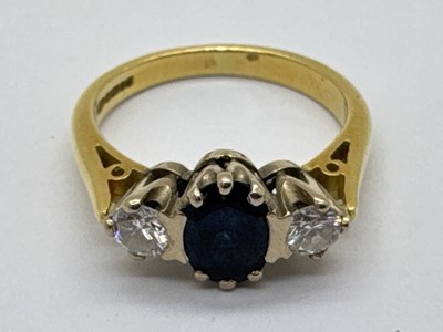 Lot 284 - An 18ct Gold Three Stone Diamond and Sapphire...
