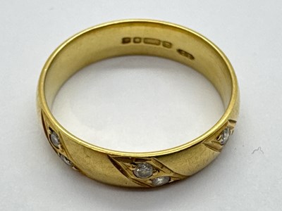 Lot 266 - An 18ct Gold Diamond Inset Band, the collet...