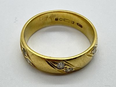 Lot 265 - An 18ct Gold Diamond Inset Band, the collet...