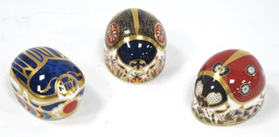 Lot 1121 - Three Royal Crown Derby Porcelain Paperweights,...