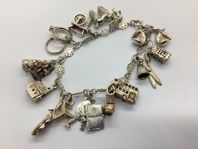 Lot 107 - A Fancy Panel Link Charm Bracelet, suspending...