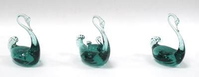 Lot 1210 - Three Green Glass Swan Paperweights, 13cm high....