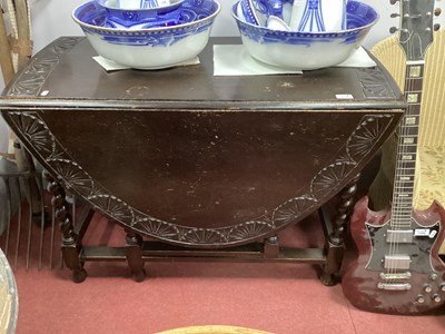 Lot 1513 - 1930s Oak Drop Leaf Table, with a carved...
