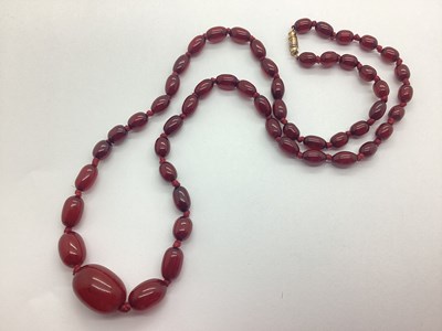 Lot 128 - A Cherry Amber Coloured Beaded Necklace, the...