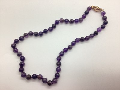 Lot 127 - A Polished Hardstone Beaded Necklace, knotted...