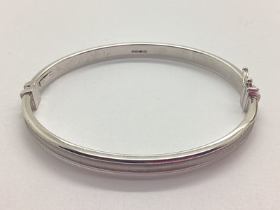 Lot 140 - A Hollow Hinged Bangle, of uniform design,...
