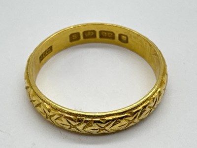 Lot 61 - A 22ct Gold Wedding Band, of allover textured...