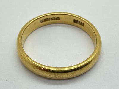 Lot 62 - A 22ct Gold Wedding Band, of plain slim design...