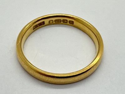 Lot 64 - A 22ct Gold Slim Wedding Band, of plain design...