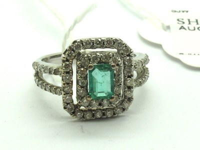 Lot 225 - An Emerald and Diamond Cluster Dress Ring, the...