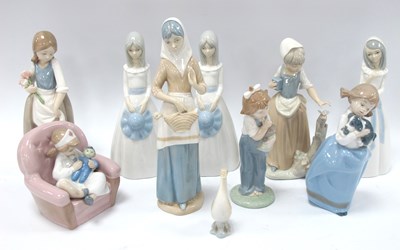 Lot 1185 - Nao figurines to include girl playing nurse,...