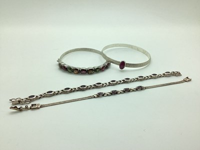 Lot 175 - A Multi Gem Det Hinged Bangle, claw set to the...