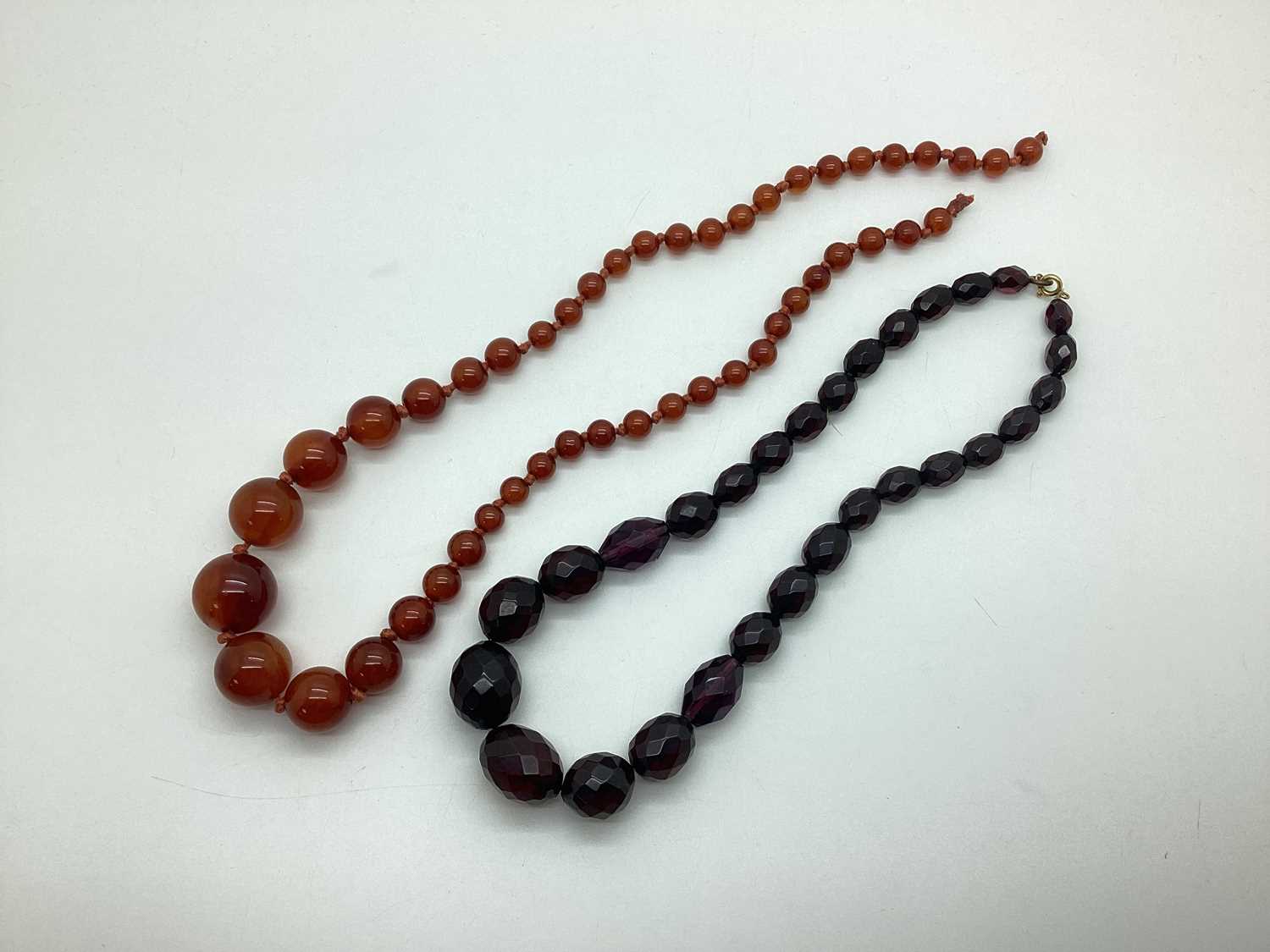 Lot 129 - A Cherry Amber Coloured Graduated Single...