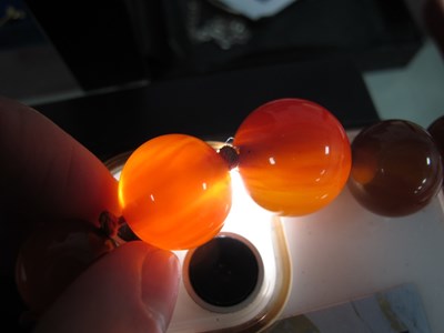 Lot 129 - A Cherry Amber Coloured Graduated Single...