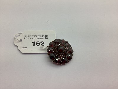 Lot 162 - A Garnet Circular Brooch, graduated claw and...