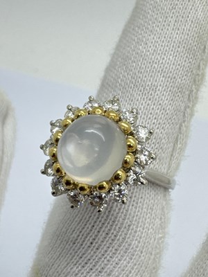 Lot 242 - A Modern Moonstone and Diamond Circular...