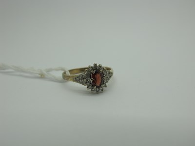 Lot 311 - A 9ct Gold Diamond Set Cluster Ring, oval claw...