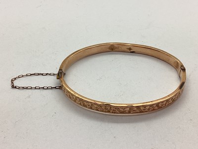 Lot 104 - A 9ct Rose Gold Hinged Bangle, leaf engraved...