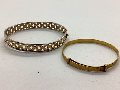 Lot 105 - A Modern 9ct Two Colour Gold Openwork Bangle,...