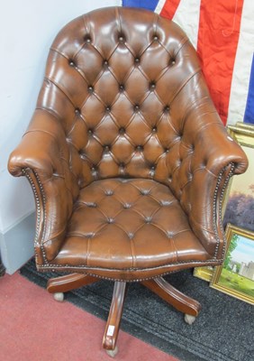 Lot 1650 - A Brown Leather Button Back Swivel Office...
