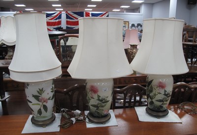 Lot 1285 - Three ceramic table lamps with brass mounts,...