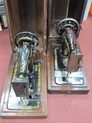 Lot 1593 - Two wooden cased Singer sewing machines...