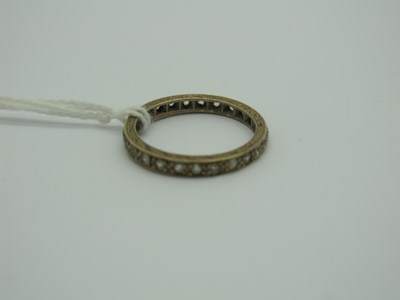 Lot 296 - An Eternity Band, inset throughout, stamped...