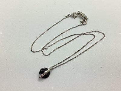 Lot 173 - A Modern Circular Pendant, the polished...