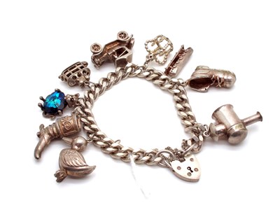 Lot 103 - A Curb Link Charm Bracelet, to hallmarked...